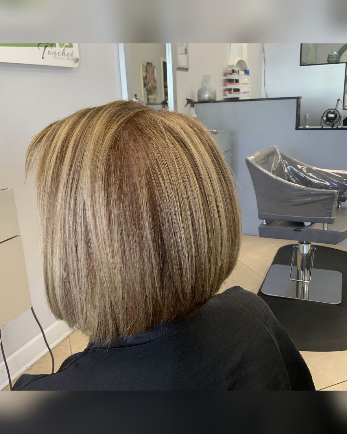 Dimensional blonde bob with a clean line — Toucheé Organic Salon, Juno Beach